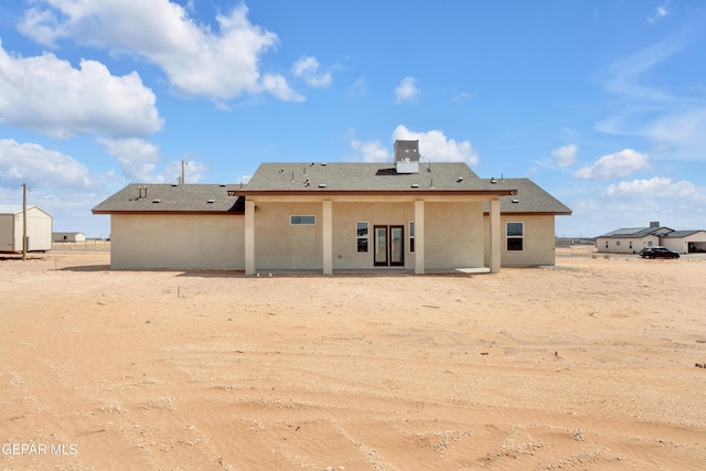 1385 Syrian Desert Dr, Chaparral, NM 88081 - rear view of house with stucco siding, a shed, and a patio area