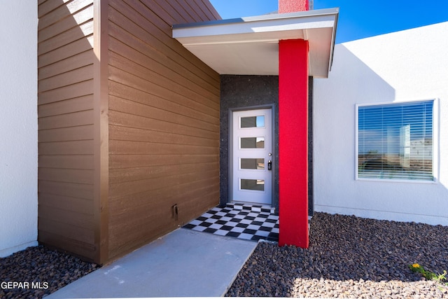 view of exterior entry featuring stucco siding