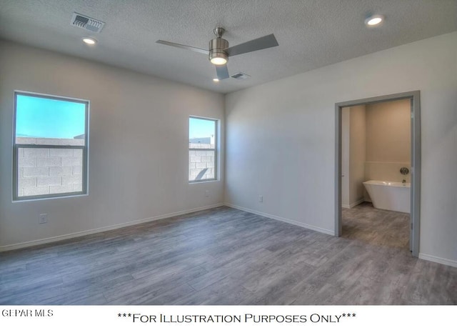 empty room with a textured ceiling, ceiling fan, and hardwood / wood-style flooring