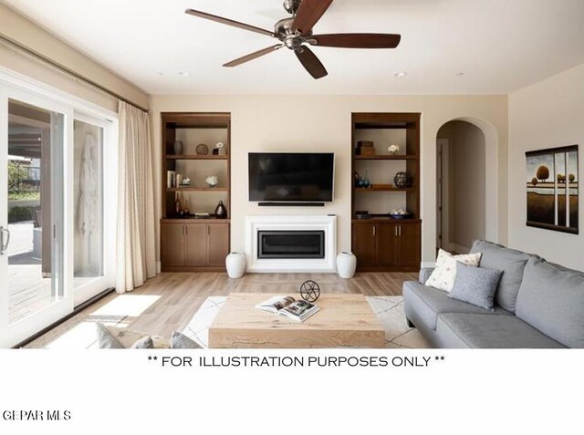 living room featuring built in features, ceiling fan, and light wood-type flooring