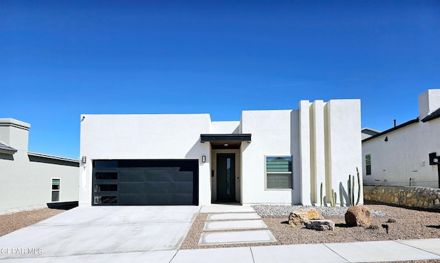 pueblo-style home with a garage