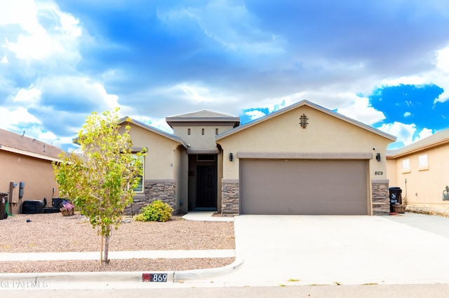 view of front facade featuring a garage, stone siding, driveway, and stucco siding