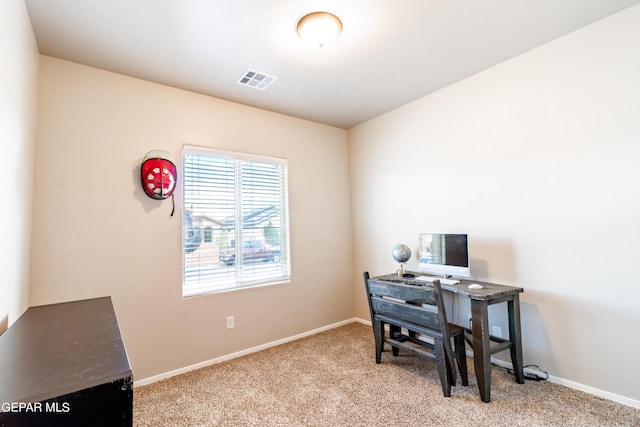 carpeted office space with baseboards and visible vents