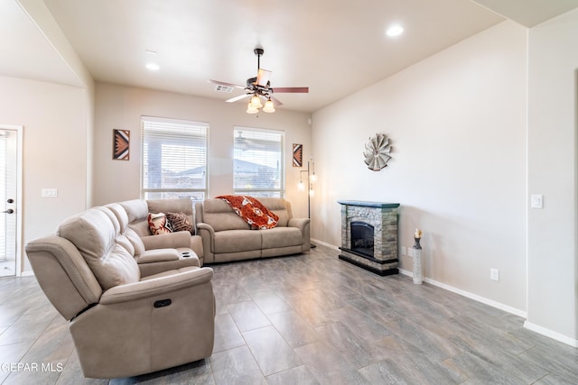 living room with a fireplace, recessed lighting, visible vents, ceiling fan, and baseboards