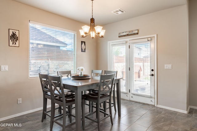 dining room with visible vents, a notable chandelier, and baseboards