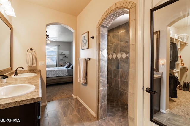 bathroom featuring a walk in shower, ensuite bath, a sink, and a ceiling fan