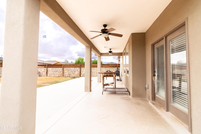 view of patio / terrace featuring a ceiling fan and fence