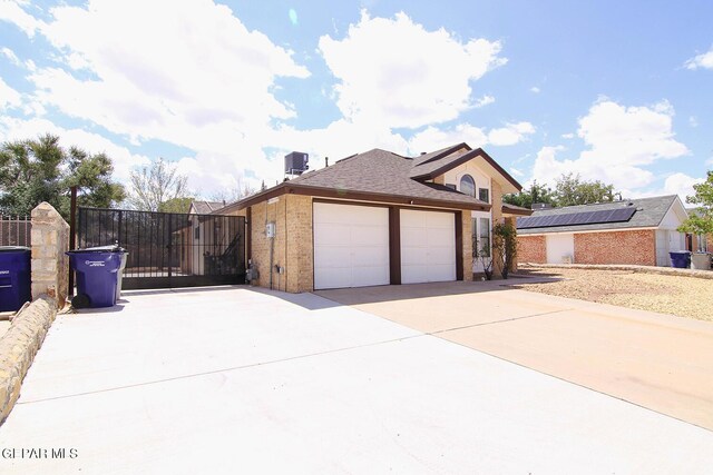 view of side of home featuring solar panels and a garage