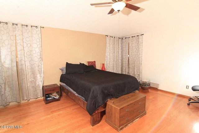 bedroom with ceiling fan and light hardwood / wood-style floors