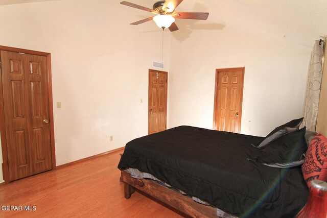 bedroom featuring lofted ceiling, ceiling fan, and light hardwood / wood-style floors