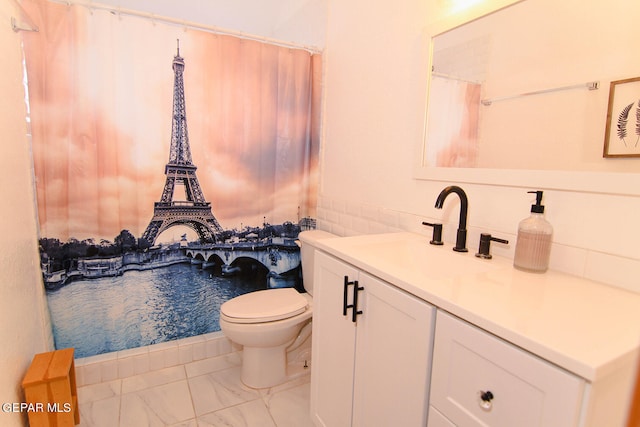 bathroom featuring vanity, toilet, and a water view