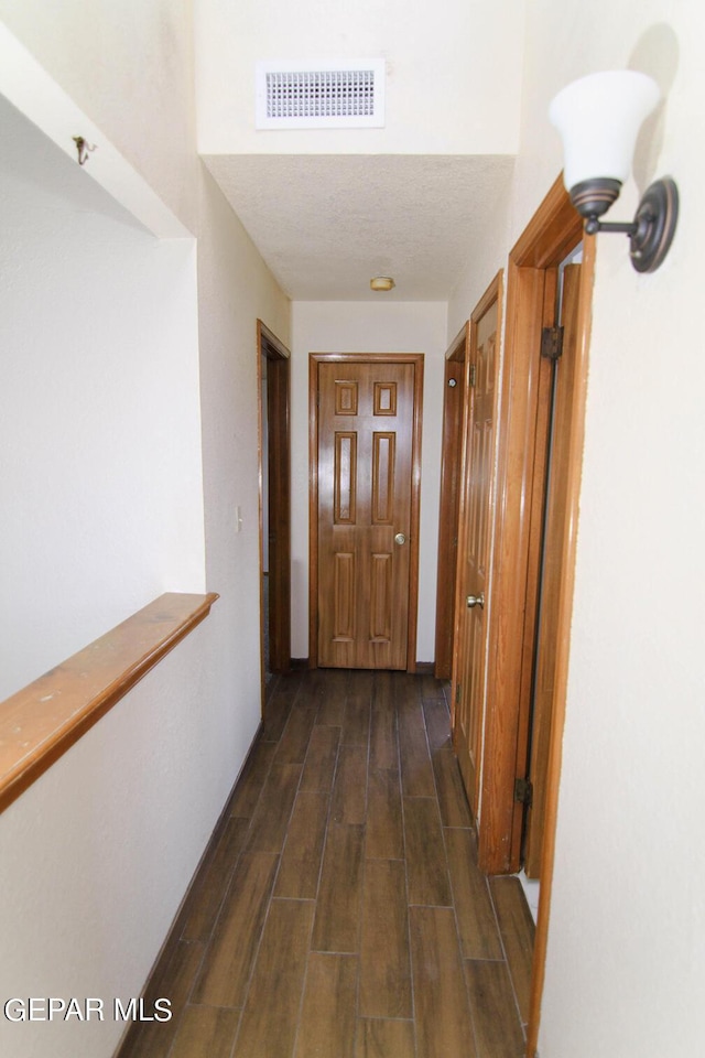 hall featuring visible vents and wood tiled floor