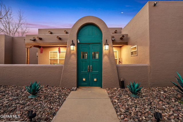 view of exterior entry at dusk