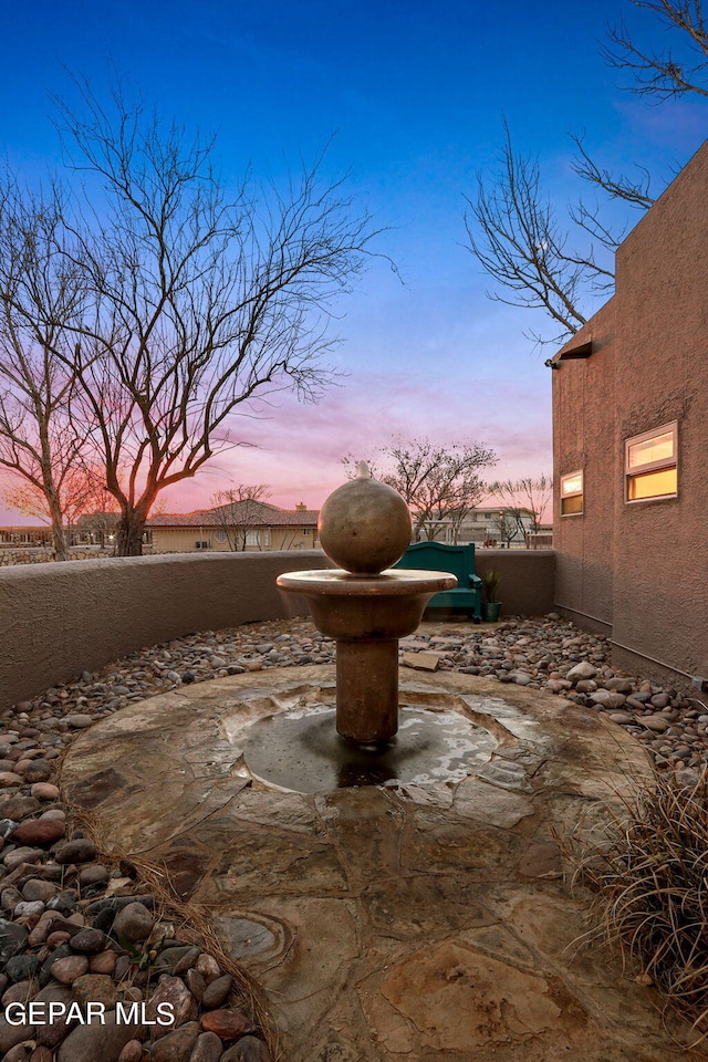 view of patio terrace at dusk