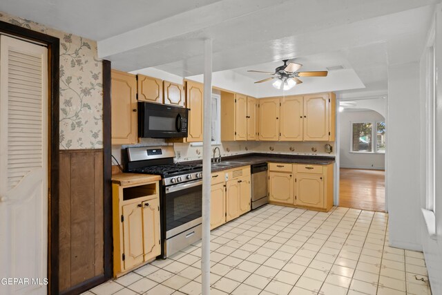 kitchen with ceiling fan, stainless steel appliances, light tile patterned flooring, and sink