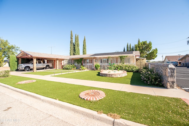 ranch-style house featuring a carport and a front yard