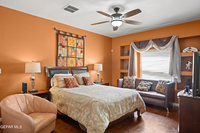 bedroom with ceiling fan and dark hardwood / wood-style floors