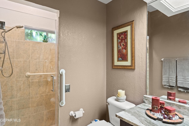 bathroom featuring tiled shower, toilet, and vanity