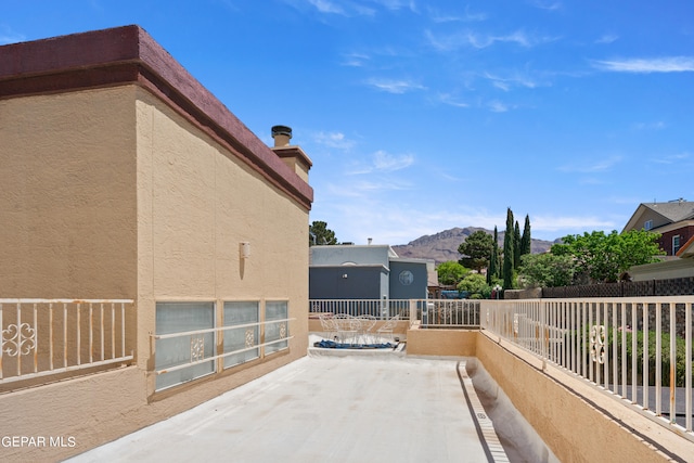 view of patio / terrace featuring a mountain view and a balcony