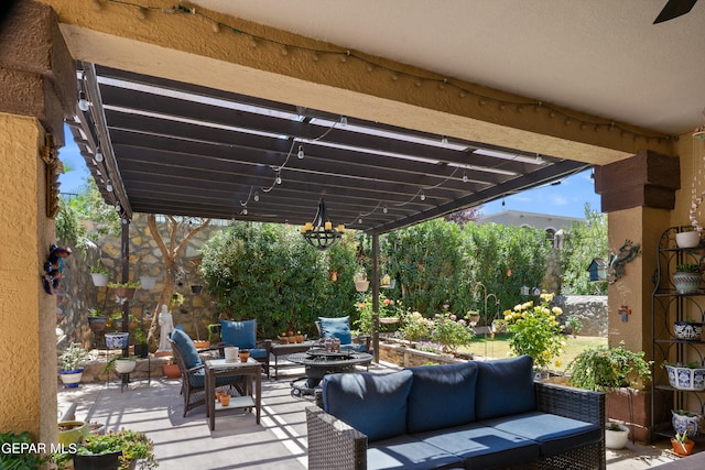 view of patio featuring an outdoor living space with a fire pit and a pergola