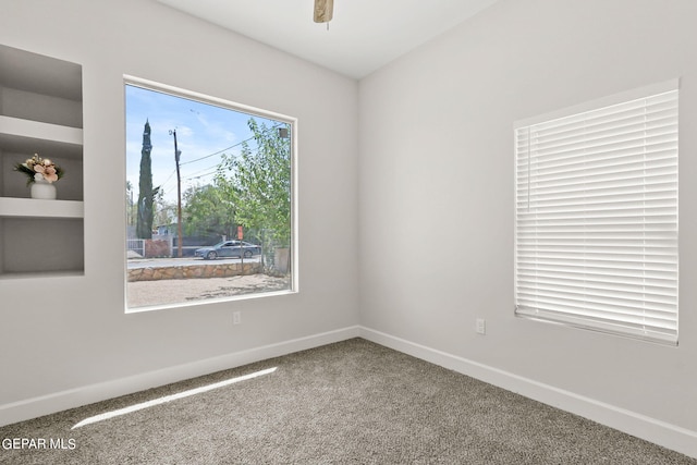 carpeted empty room featuring ceiling fan