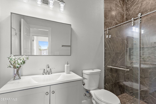 bathroom featuring vanity, toilet, and a shower with door