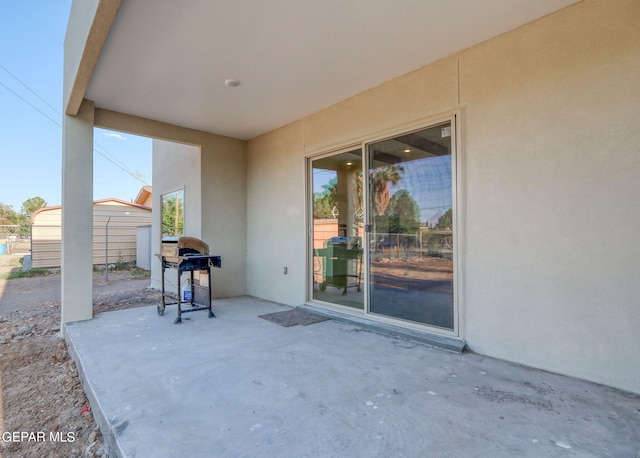 view of patio / terrace with grilling area and a shed