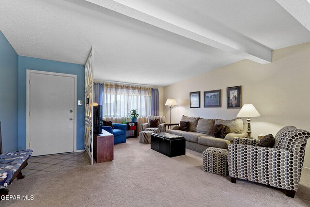 living room featuring a textured ceiling, light colored carpet, and beam ceiling