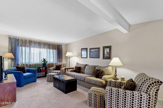 living room with lofted ceiling with beams, a textured ceiling, and carpet floors