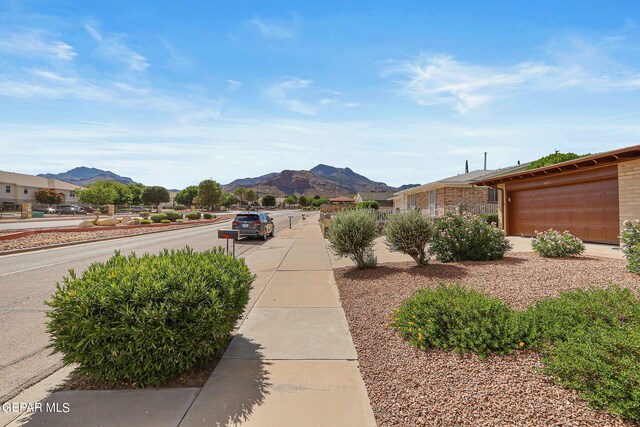 exterior space with a mountain view and a garage