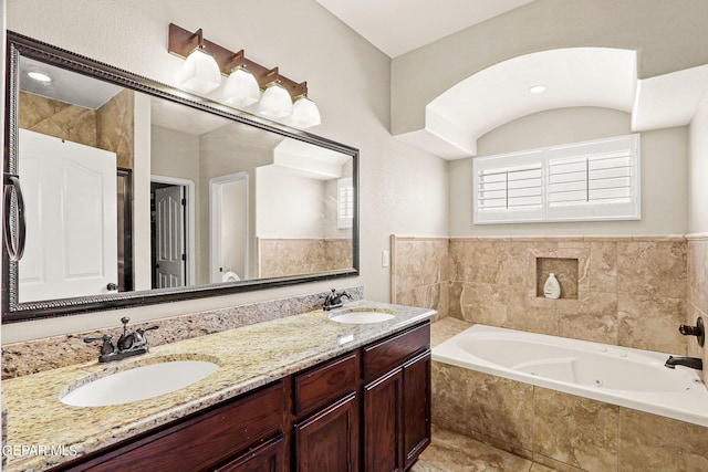 3000 Lookout Point Dr, El Paso, TX 79938 - bathroom featuring a tub with jets, double vanity, and a sink