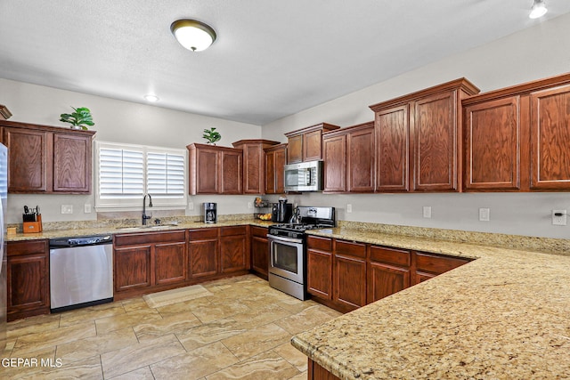 3000 Lookout Point Dr, El Paso, TX 79938 - kitchen featuring a sink, stainless steel appliances, and light stone countertops