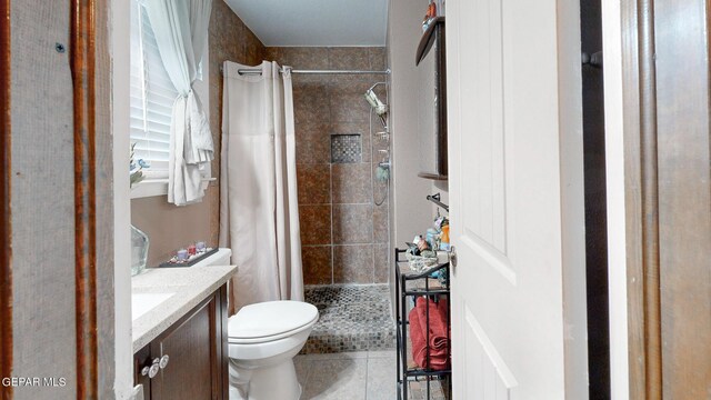 bathroom featuring vanity, toilet, walk in shower, and tile patterned floors