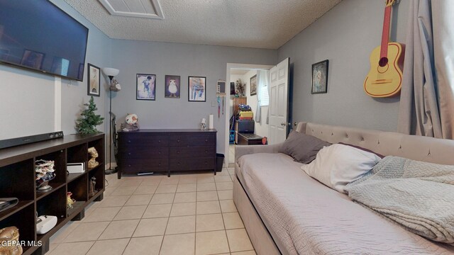 bedroom featuring a textured ceiling and light tile patterned floors