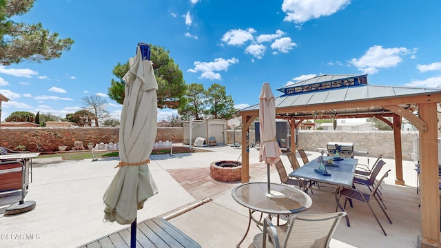 view of patio with a fire pit and a gazebo