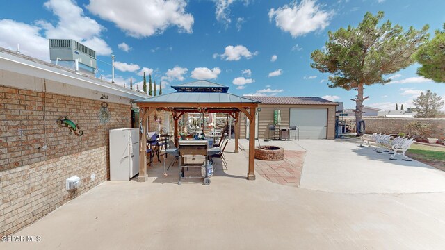 view of patio featuring a fire pit, central AC unit, and a gazebo