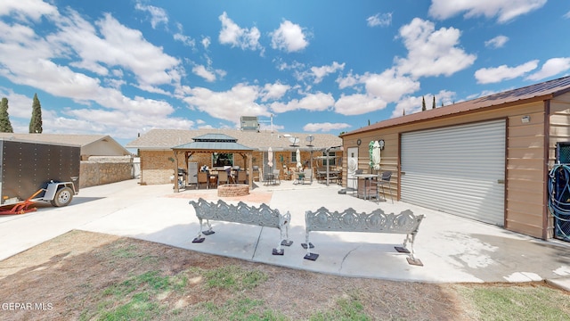 exterior space featuring an outdoor structure, a garage, and a gazebo