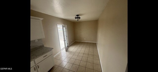 unfurnished room with light tile patterned floors