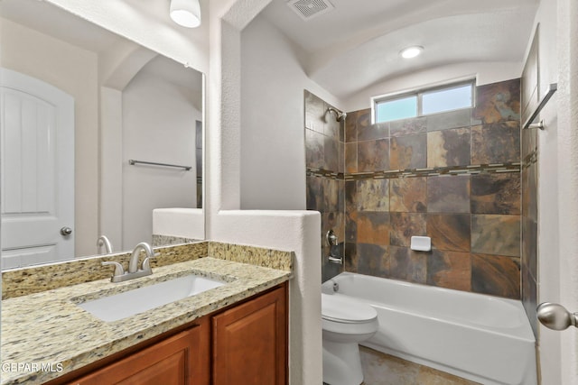 bathroom featuring vanity, toilet, visible vents, and shower / washtub combination