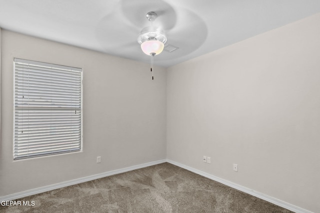 spare room with visible vents, ceiling fan, baseboards, and carpet floors