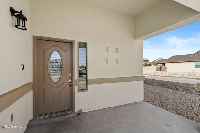 property entrance with stucco siding