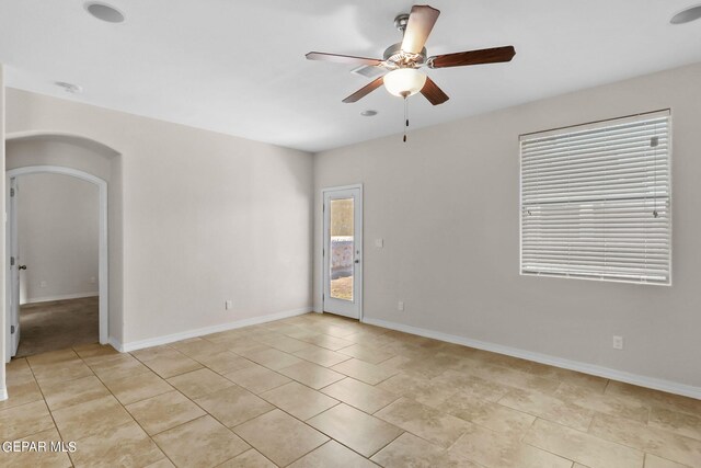 tiled empty room with ceiling fan