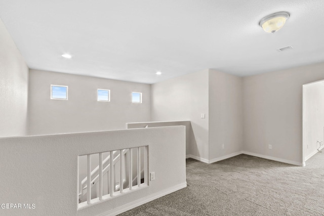 empty room with recessed lighting, carpet flooring, baseboards, and visible vents