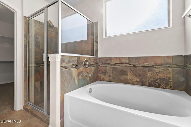 bathroom featuring independent shower and bath and tile patterned floors