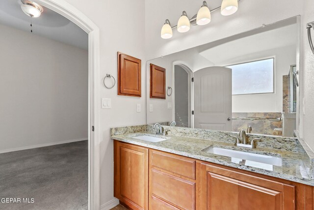 bathroom featuring ceiling fan and vanity