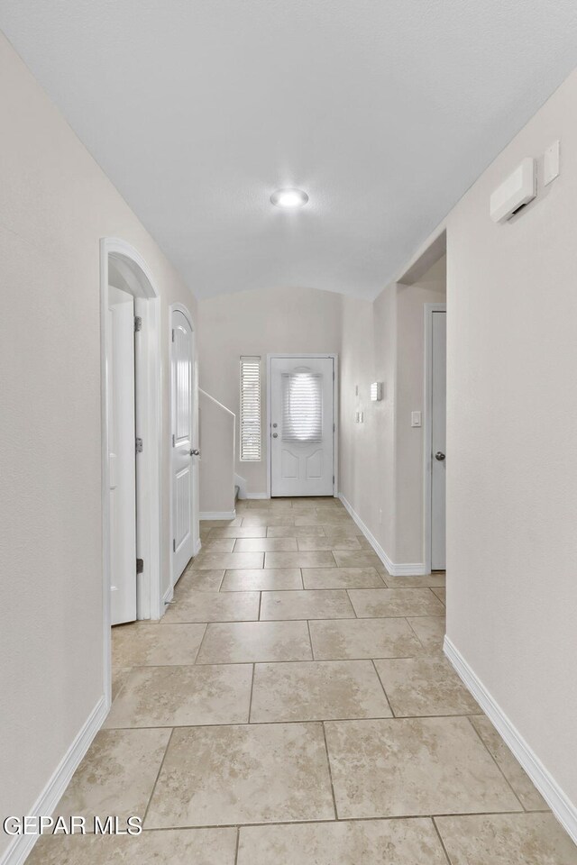 tiled entrance foyer with lofted ceiling