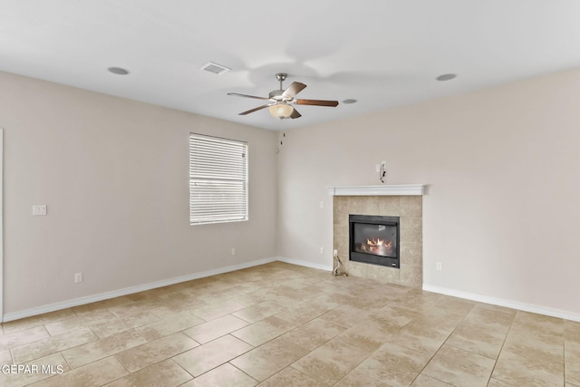 unfurnished living room featuring visible vents, baseboards, a tiled fireplace, light tile patterned floors, and a ceiling fan