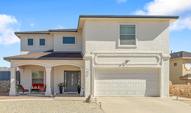 view of front of home with a porch and a garage