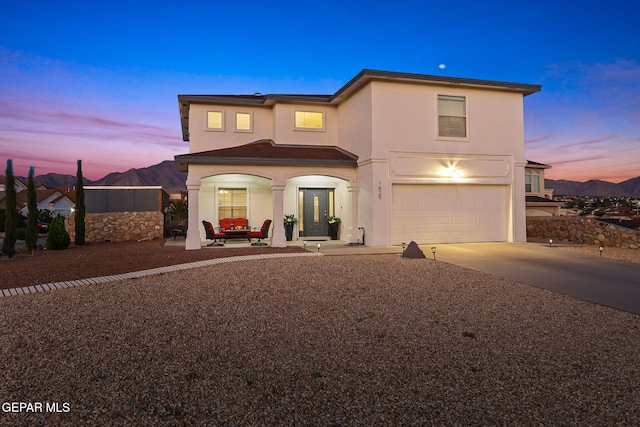 front of property featuring a mountain view and a garage