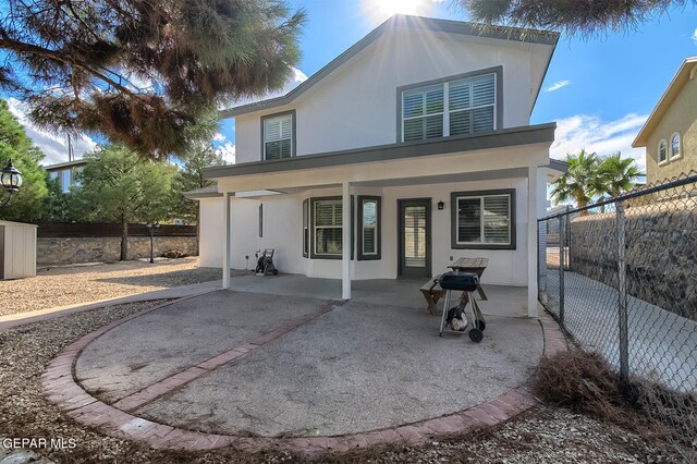 back of property with a porch